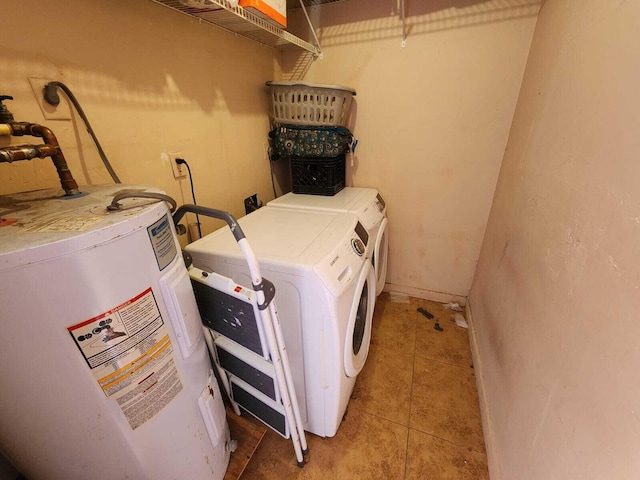 clothes washing area with laundry area, light tile patterned floors, separate washer and dryer, and electric water heater