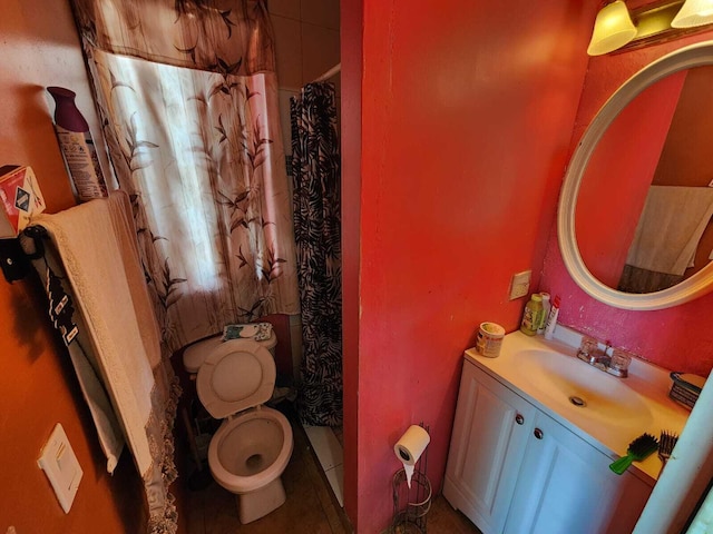 bathroom with vanity, toilet, a shower with shower curtain, and tile patterned floors