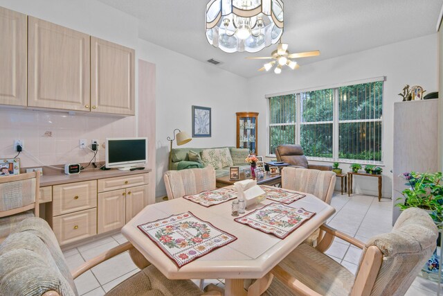 dining room with an inviting chandelier and light tile patterned floors