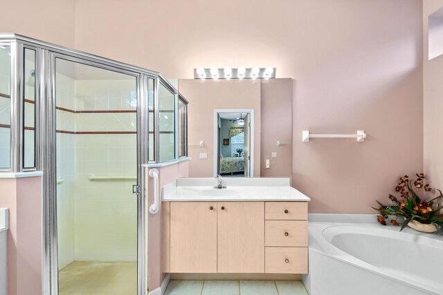 bathroom featuring tile patterned flooring, vanity, and independent shower and bath