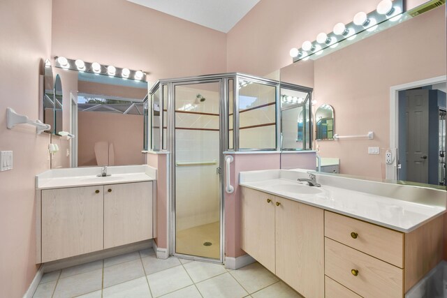 bathroom featuring tile patterned floors, an enclosed shower, and vanity