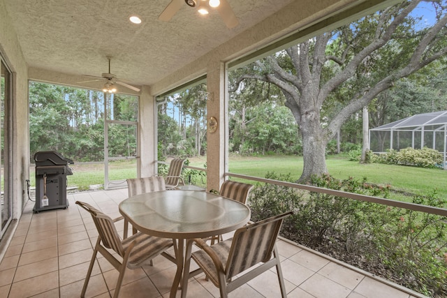 sunroom featuring ceiling fan