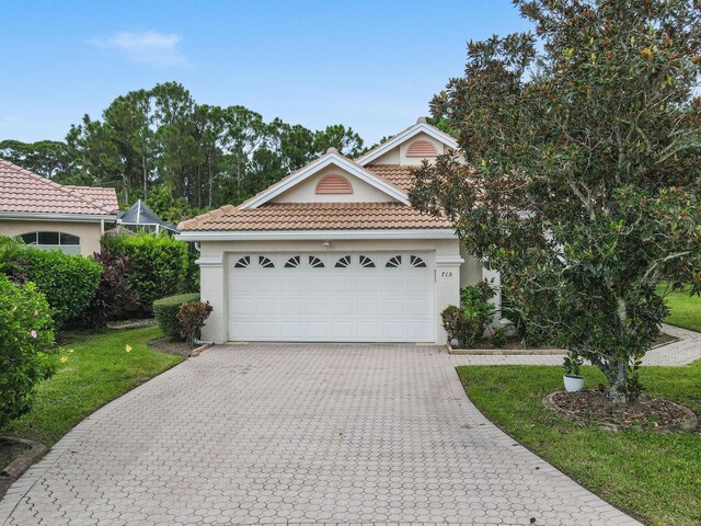 view of front facade with a garage and a front lawn