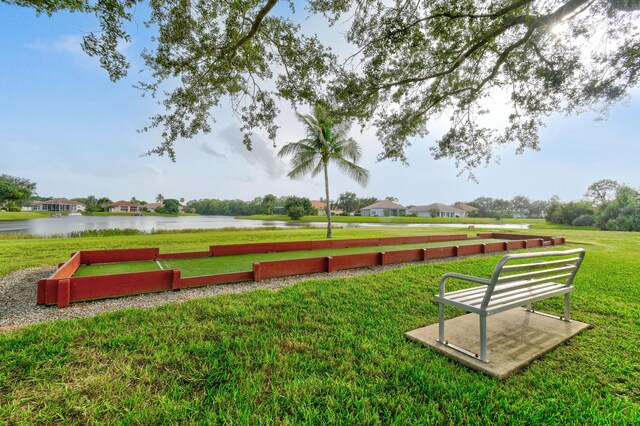 view of home's community featuring a water view and a yard