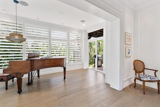 misc room with crown molding and light hardwood / wood-style floors