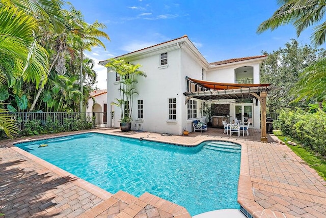 exterior space with a fenced in pool, a pergola, and a patio area