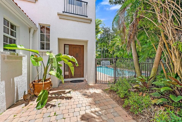 property entrance featuring a fenced in pool