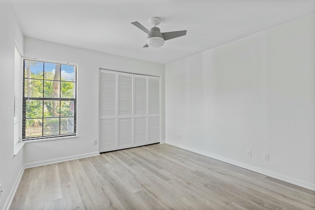 unfurnished bedroom with ceiling fan, light hardwood / wood-style floors, and a closet