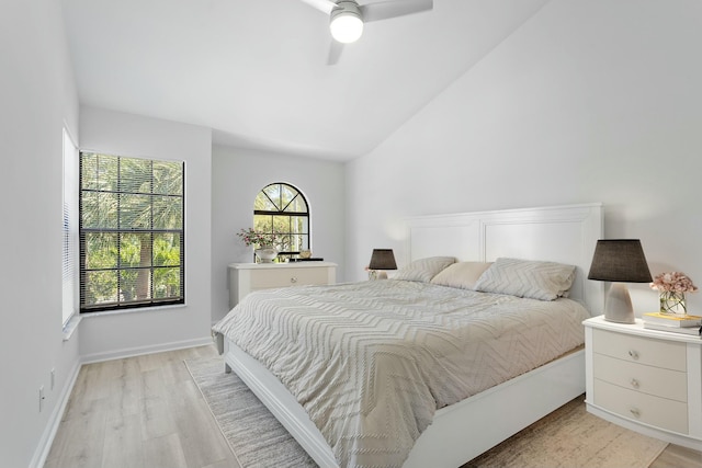 bedroom with light hardwood / wood-style flooring, vaulted ceiling, and ceiling fan