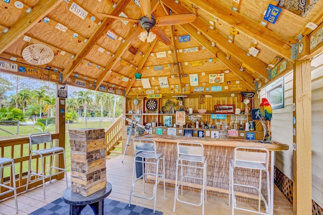 view of patio with a gazebo, ceiling fan, and exterior bar