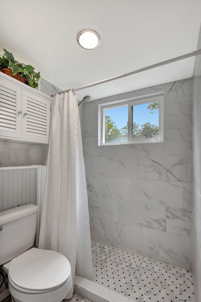 bathroom featuring toilet and a shower with shower curtain