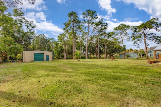 view of yard with a garage and an outdoor structure