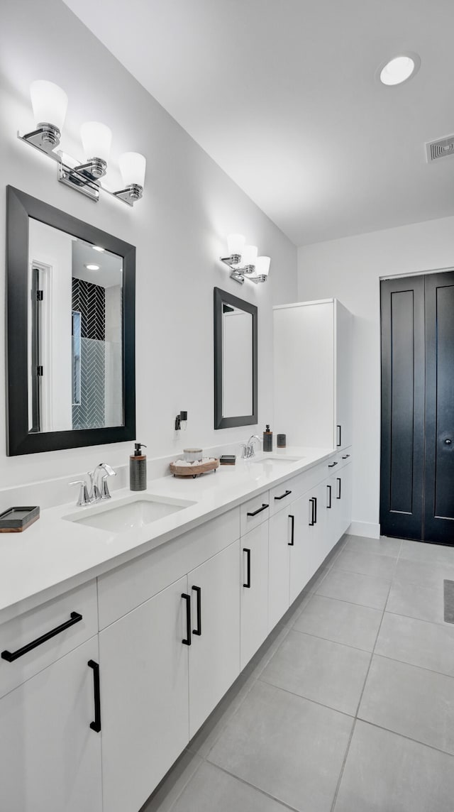 bathroom with tile patterned floors and vanity