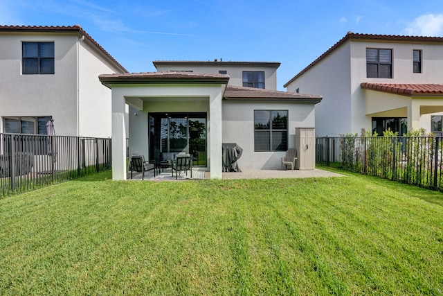 rear view of property featuring a yard and a patio