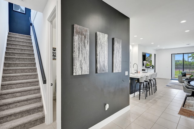 staircase featuring tile patterned floors, recessed lighting, and baseboards