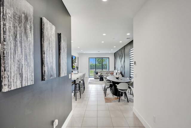 hall featuring light tile patterned flooring