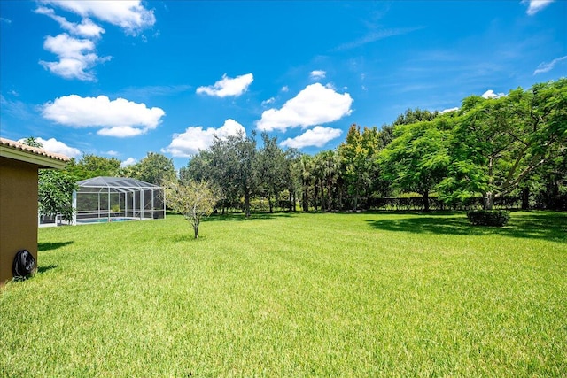 view of yard with glass enclosure