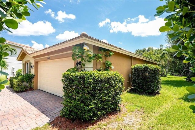 view of property exterior with a lawn and a garage