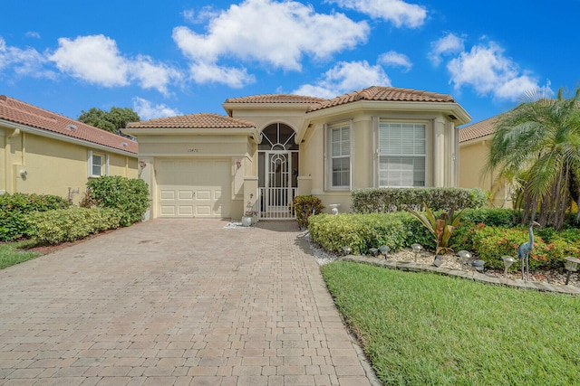 mediterranean / spanish-style house with a garage