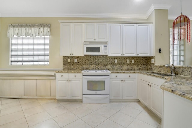 kitchen featuring white appliances, light tile patterned floors, ornamental molding, sink, and light stone counters