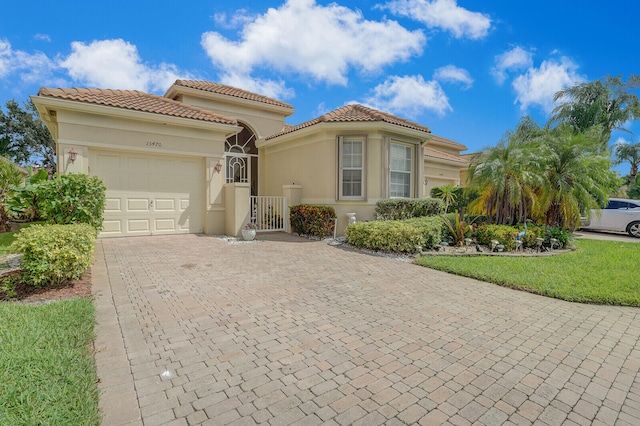 mediterranean / spanish-style home with a garage