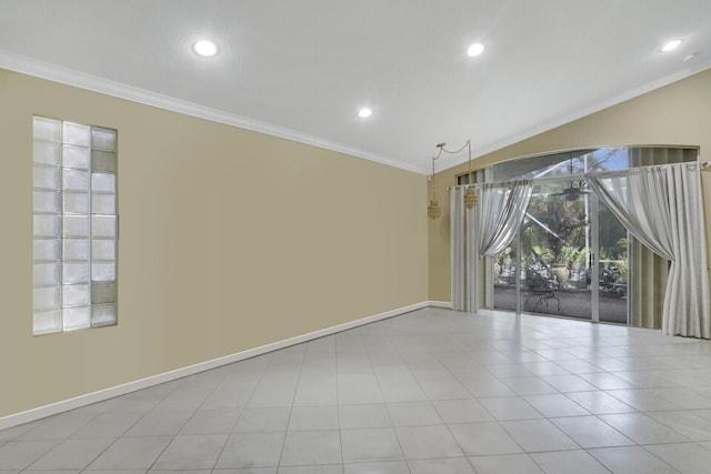 tiled empty room with lofted ceiling and crown molding