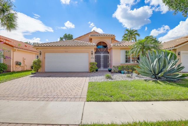 mediterranean / spanish-style house with a garage