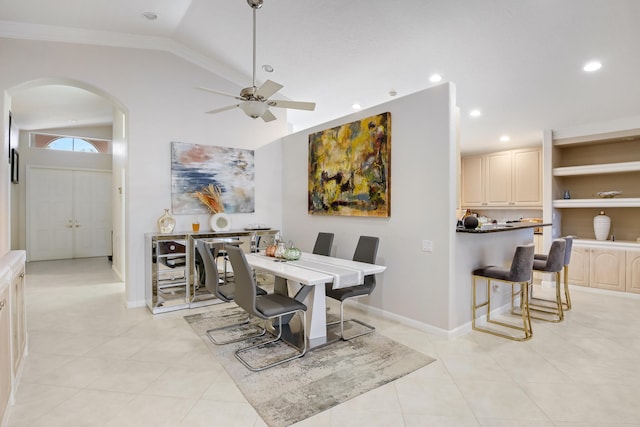 tiled dining room featuring lofted ceiling and ceiling fan