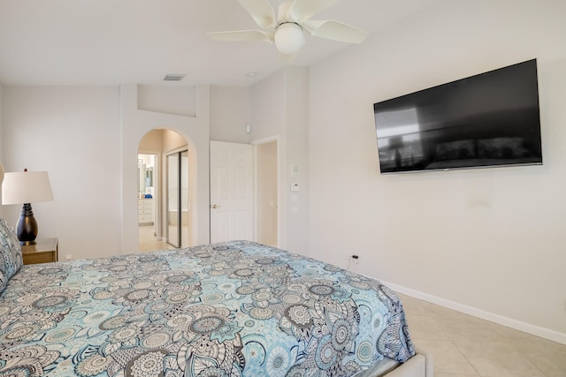 bedroom with ceiling fan and light tile patterned floors