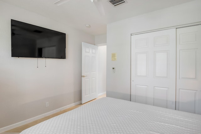 bedroom with ceiling fan and a closet