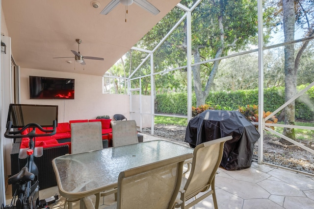 sunroom featuring ceiling fan and vaulted ceiling