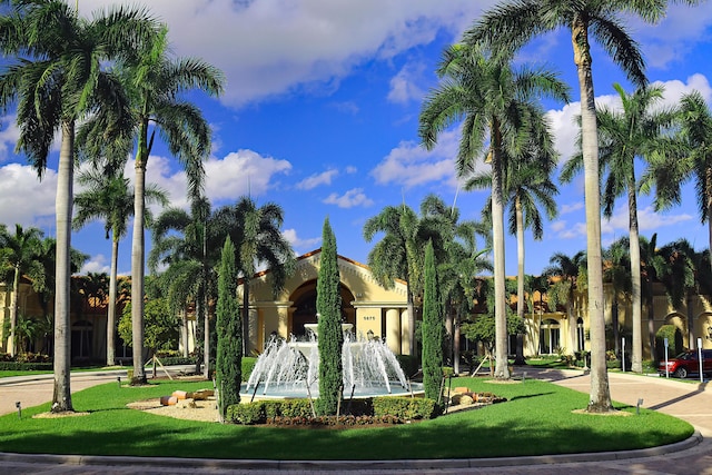 view of property's community with a lawn