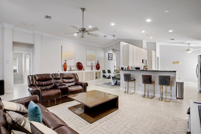 tiled living room featuring ceiling fan and ornamental molding