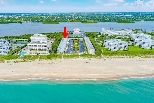 birds eye view of property featuring a water view and a view of the beach