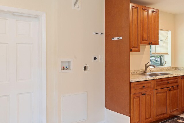 laundry room featuring washer hookup, cabinets, sink, and hookup for an electric dryer