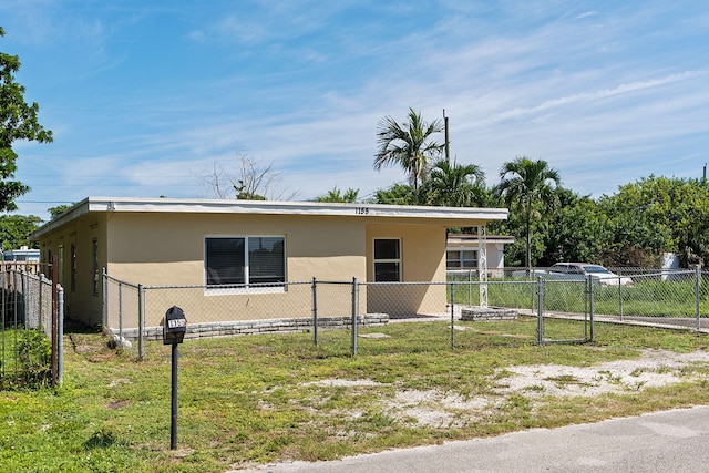 view of front of property with a front yard and a carport