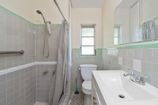 bathroom with toilet, tile patterned flooring, vanity, tile walls, and a shower with shower curtain