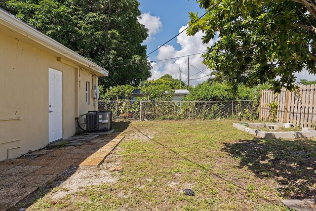 view of yard featuring central air condition unit