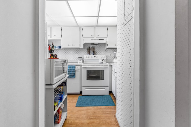 kitchen featuring light wood-type flooring, white cabinets, white appliances, and premium range hood