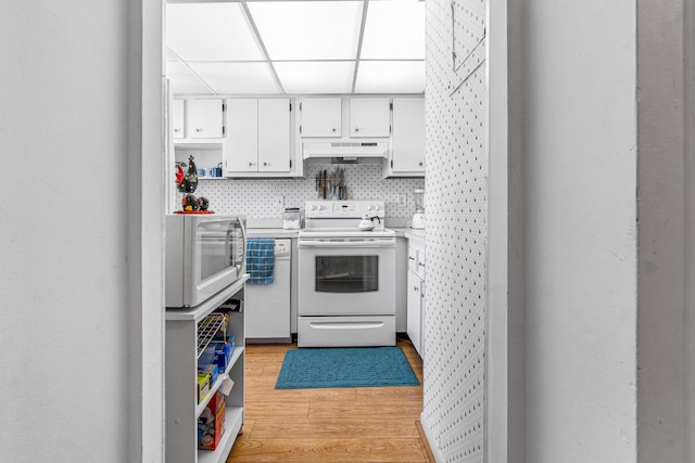 kitchen featuring white appliances, open shelves, under cabinet range hood, light wood-type flooring, and white cabinetry