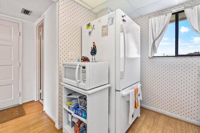 interior space with light wood-type flooring and white appliances