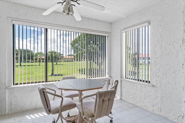 sunroom / solarium featuring ceiling fan