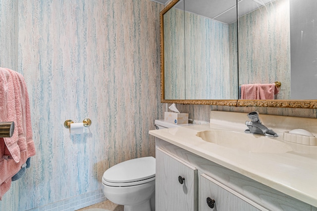 bathroom featuring toilet and vanity