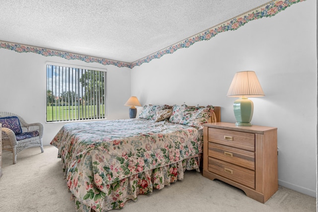 bedroom featuring a textured ceiling and light carpet