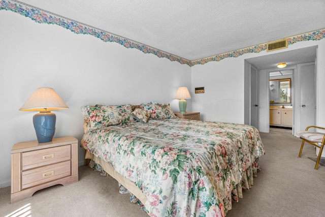 bedroom featuring a textured ceiling and carpet floors