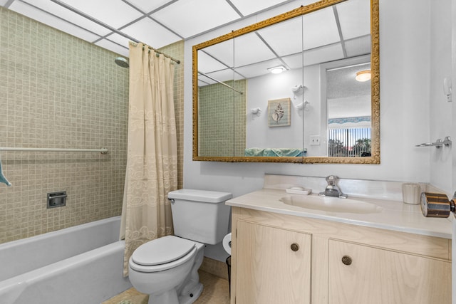 full bathroom with shower / bathtub combination with curtain, toilet, a paneled ceiling, and vanity