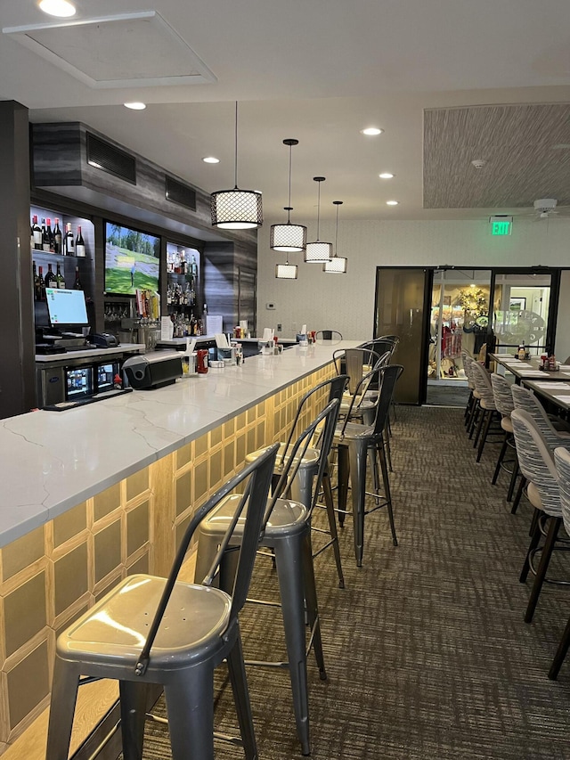 bar area with carpet floors, recessed lighting, and hanging light fixtures