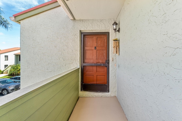 view of exterior entry featuring stucco siding
