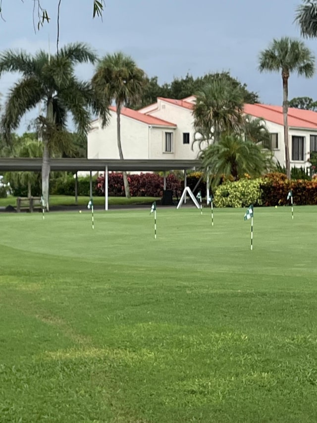 view of community featuring an area to practice putting and view of golf course