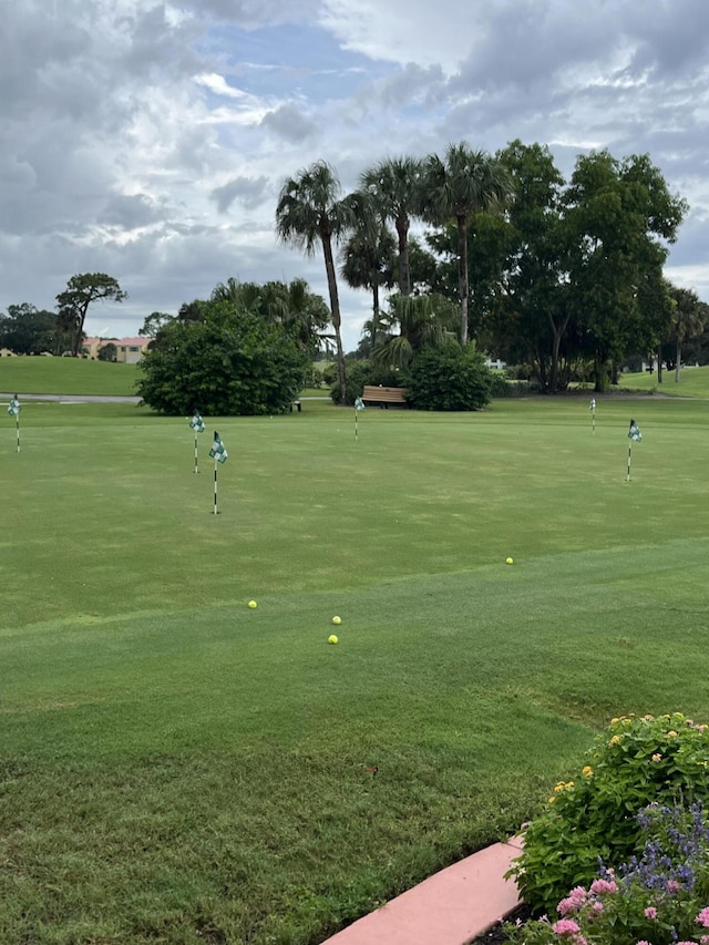 surrounding community with a putting green and view of golf course